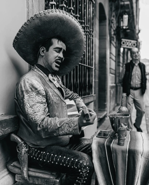 a black and white pograph of a man smoking a cigarette