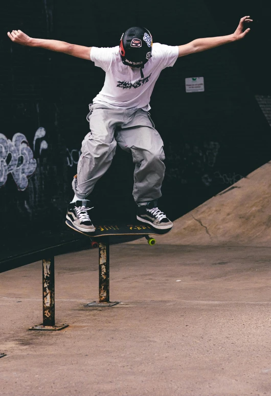 a skateboarder doing tricks on top of an obstacle