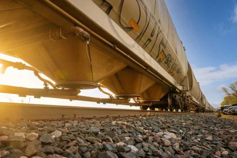 a train on the tracks under a bridge