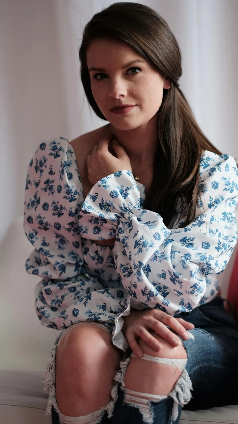 the girl is posing for the camera in her blue top