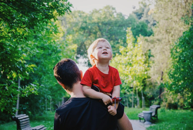 a man and a child are having a walk in a park