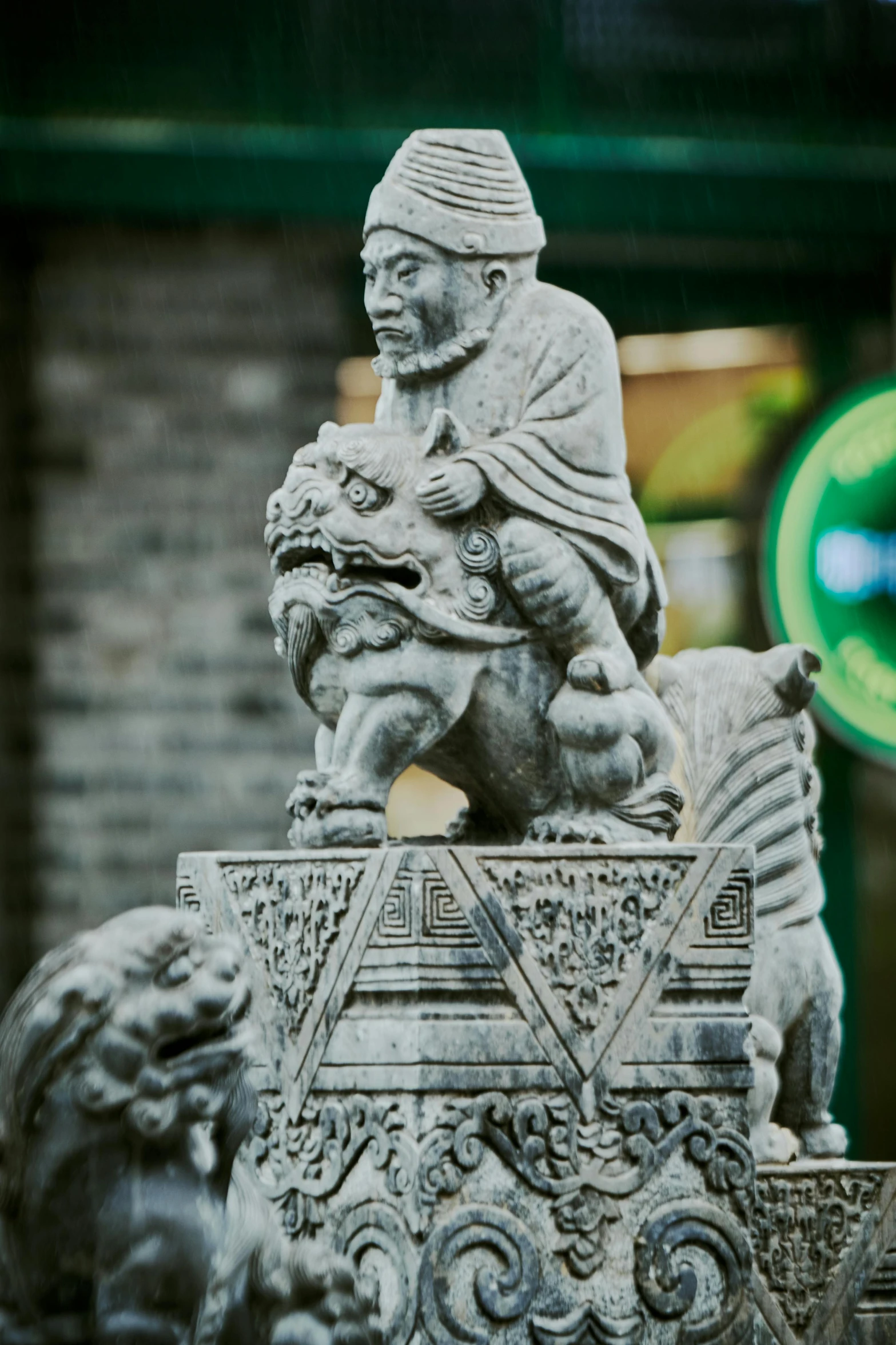 a statue with a man sitting on top of it