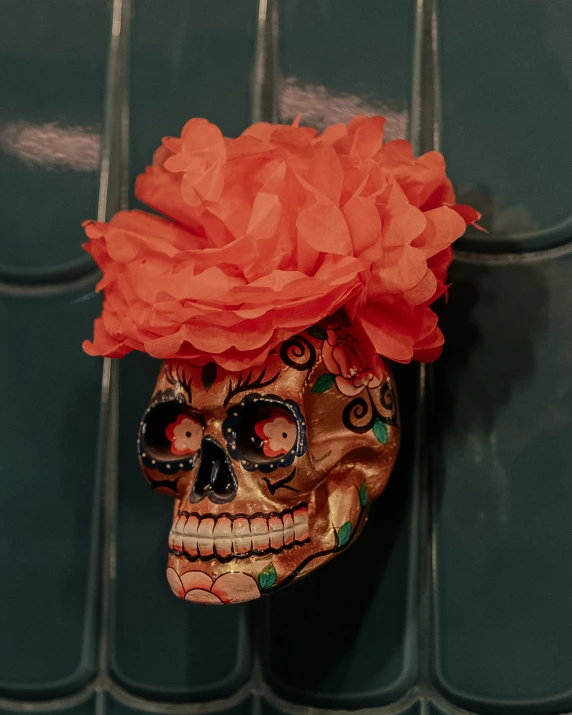 a colorfully dressed human skull is on display