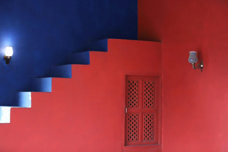 a red wall with blue walls and stairs