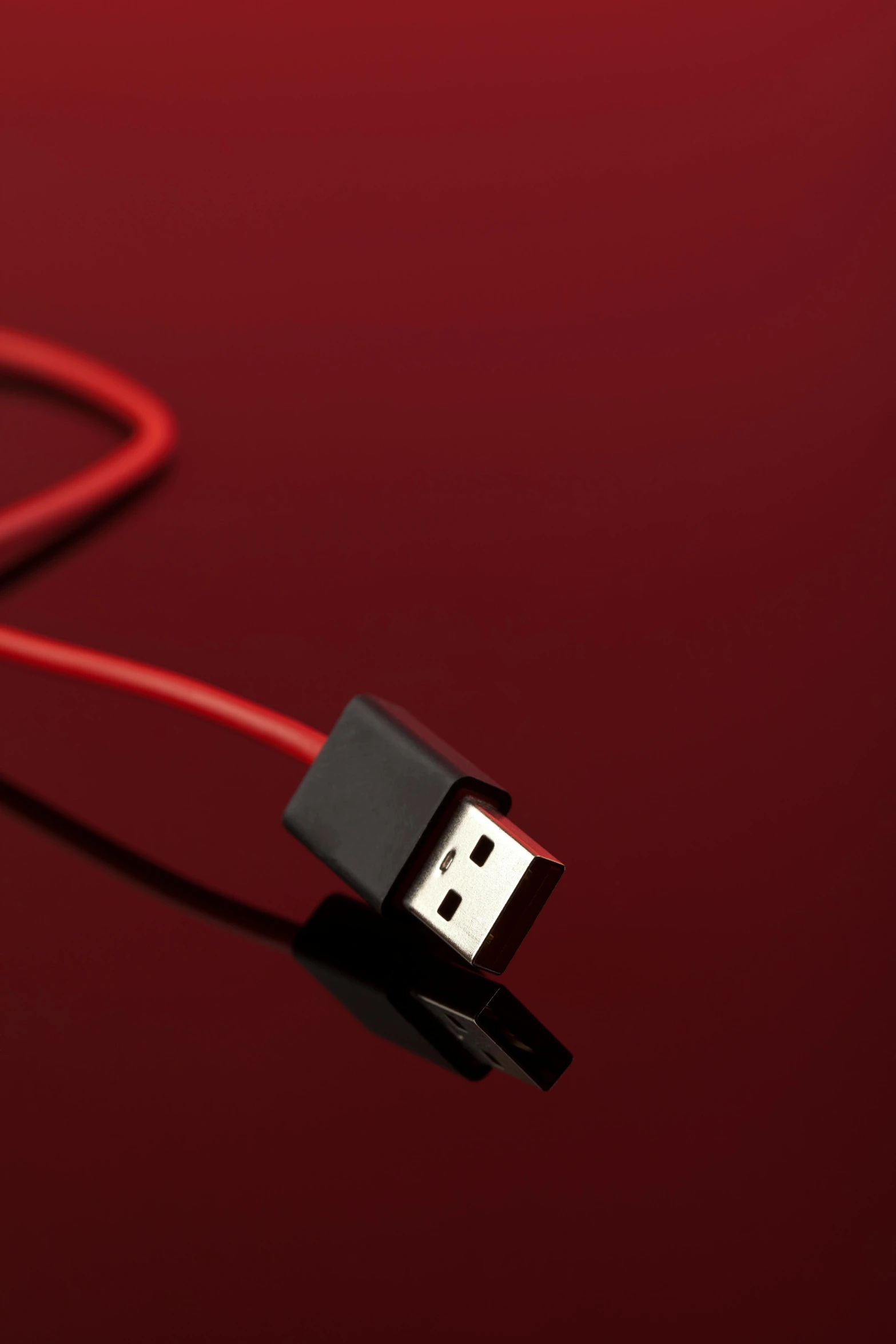 a usb cord on a red background with a red cord