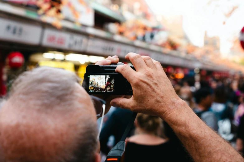 a man takes a po of the crowd of people