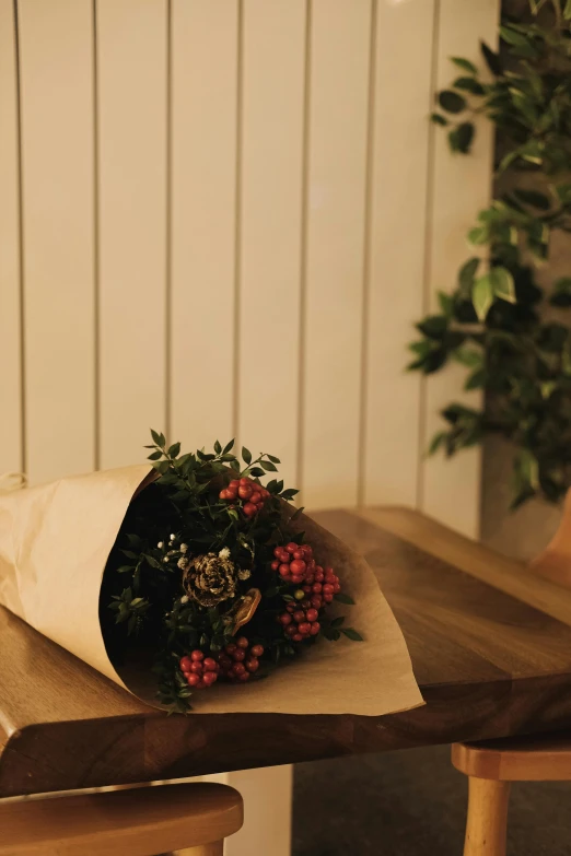 a bouquet of flowers are wrapped in brown paper