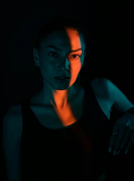 a woman is standing against a black background