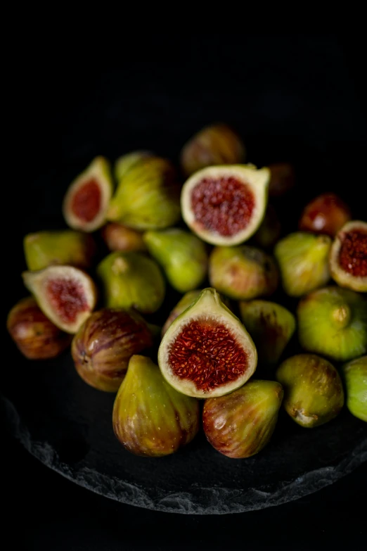 figs with seeds on a black plate