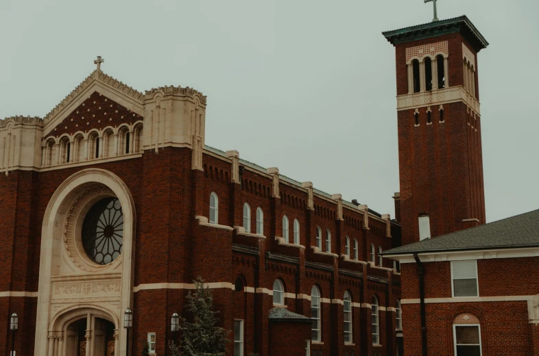 a large red brick building with a church steeple