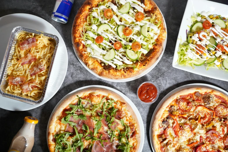 a variety of different types of pizza sitting on top of a table