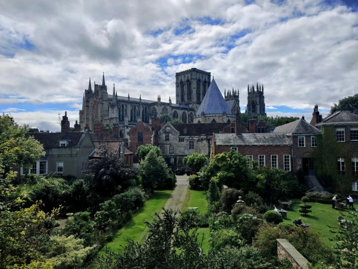 the castle sits atop a hill overlooking a lush green park