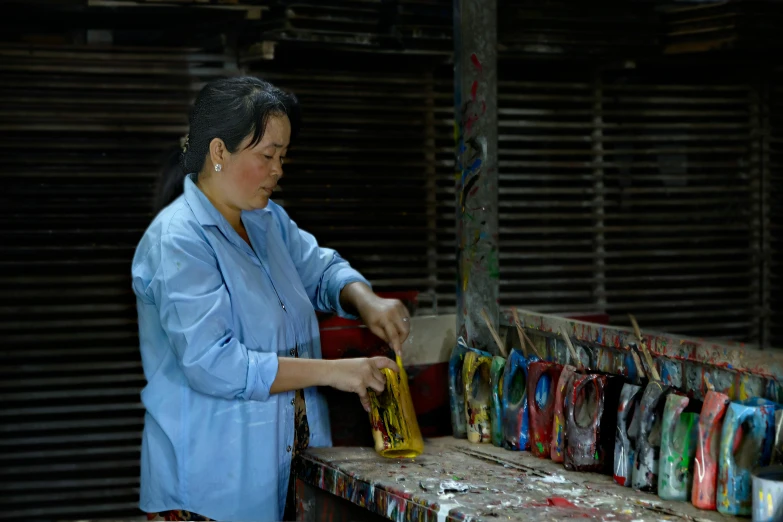 a woman is standing near a rack of items