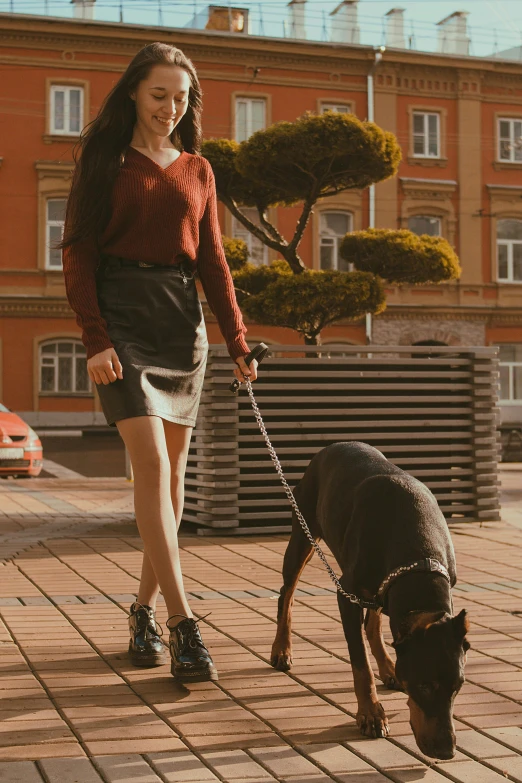 girl walking her dog across the plaza in summer