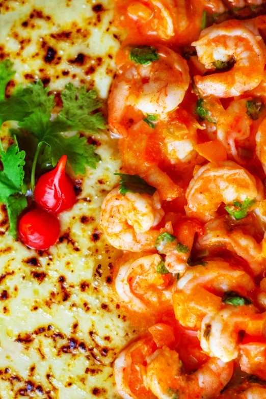 a plate of shrimp and grits with a small garnish