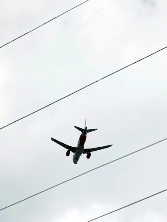 the large airplane is flying high up in the sky