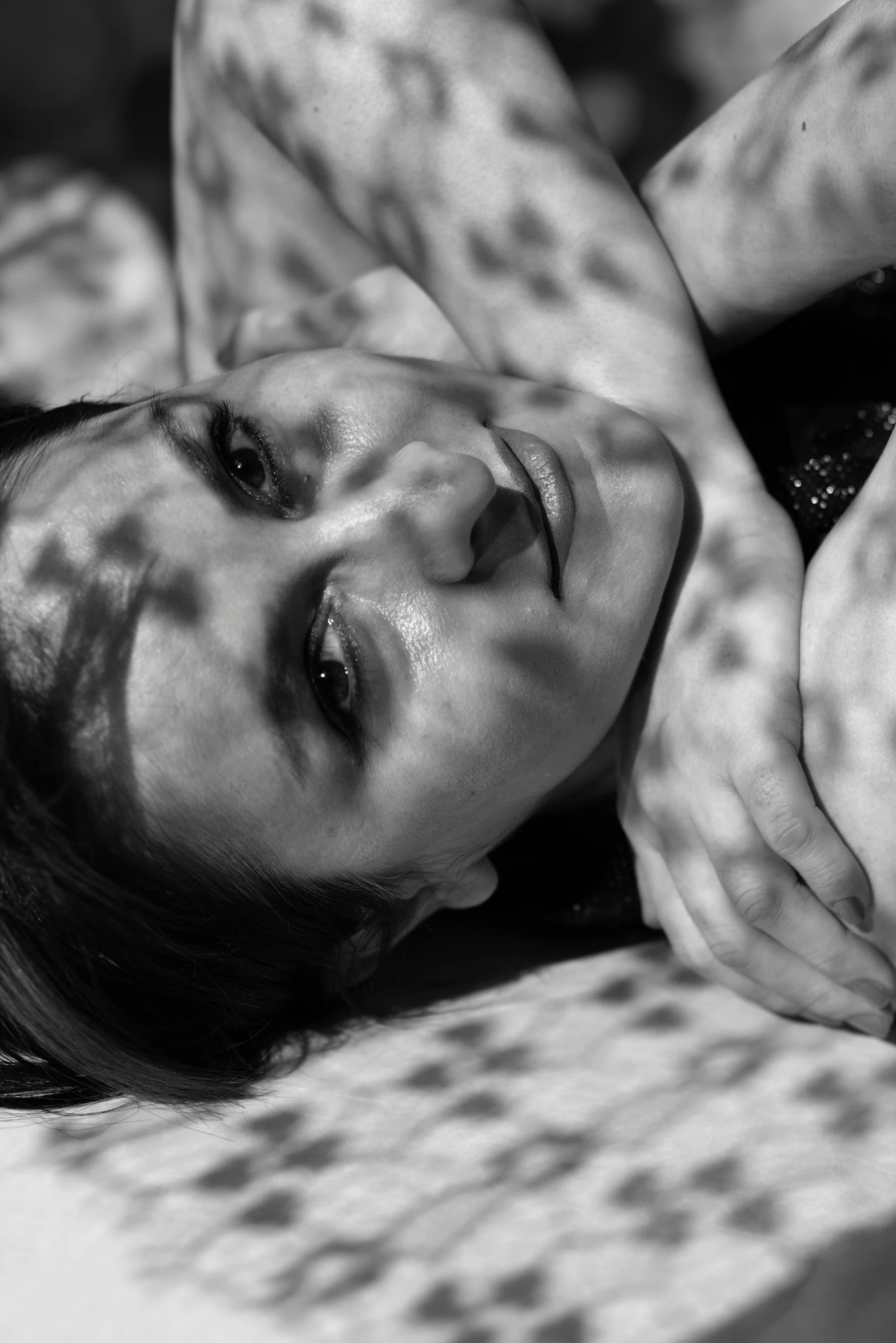 a black and white po of a woman laying on a bed