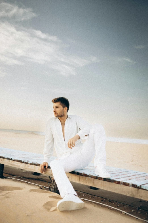 a man sitting on the edge of the pier