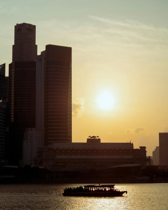 a city skyline with the sun setting in the distance