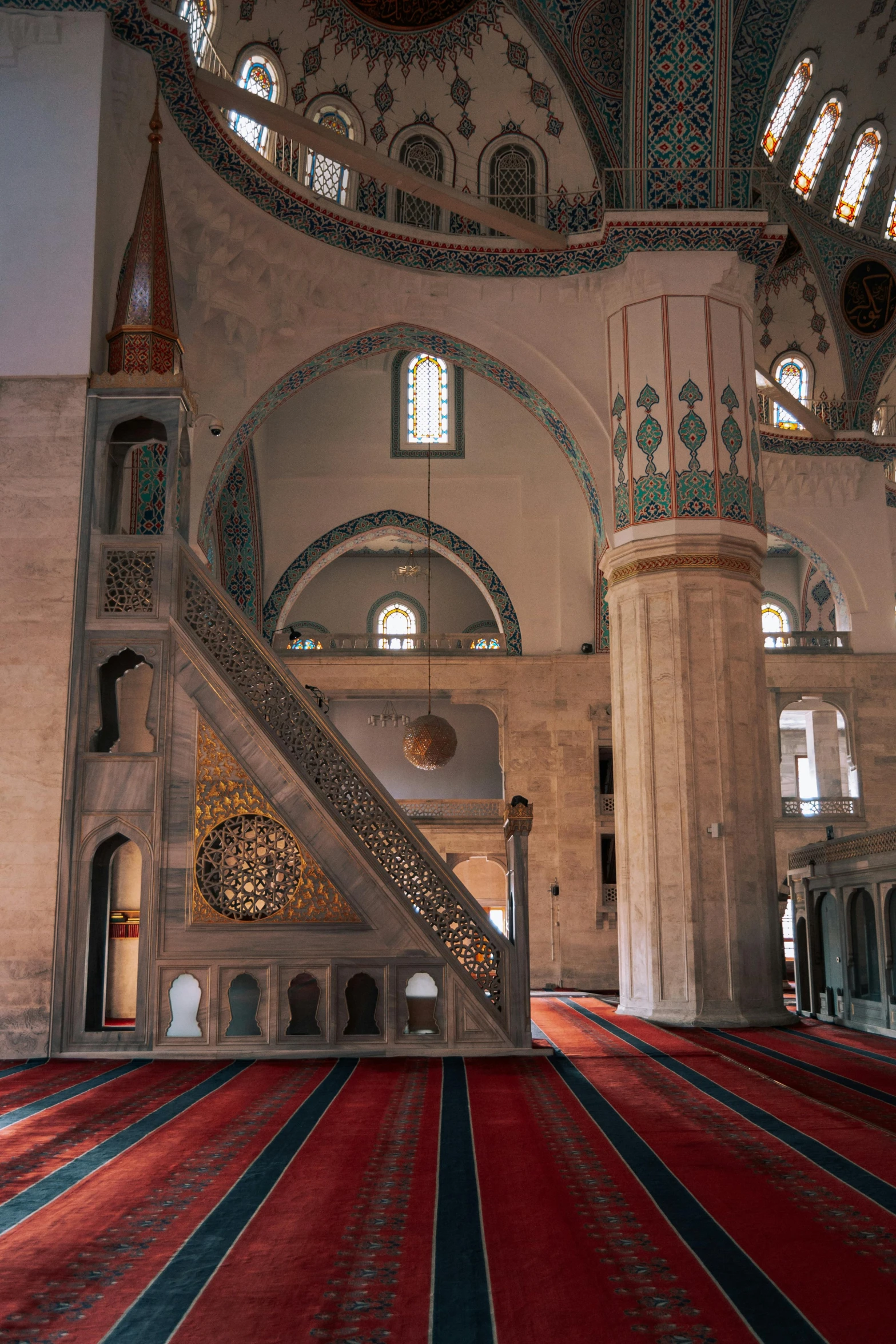 the inside of an oriental building with carpeting and pillars