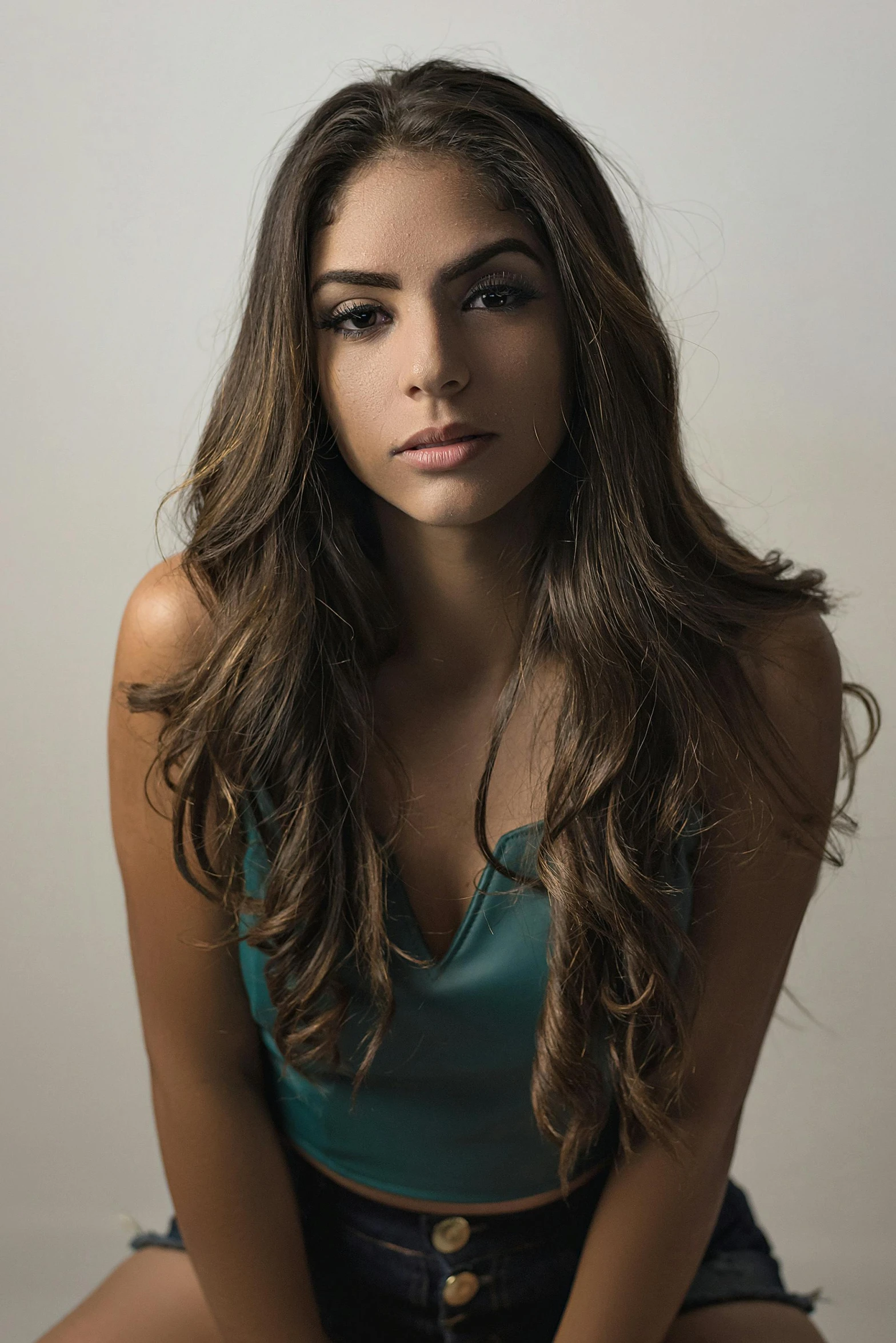 a pretty young lady with long hair and dark pants