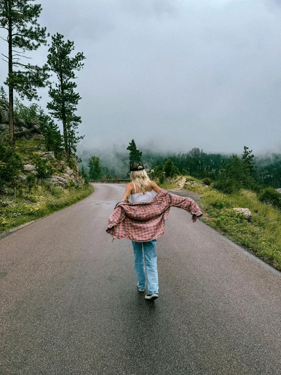 woman walking down the road in the rain