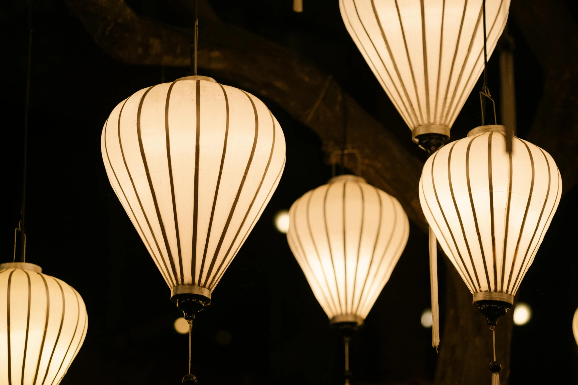 lanterns lit up for hanging in a room