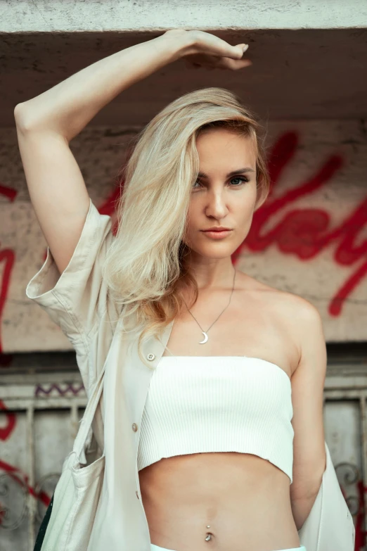 a beautiful young blonde woman in a crop top