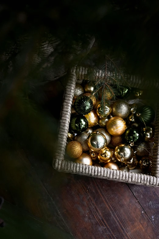 christmas ornaments are in a basket on the floor