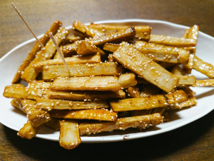 fried french fries are on a white plate