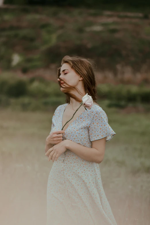 a girl with a flower in her hair blows a cigarette