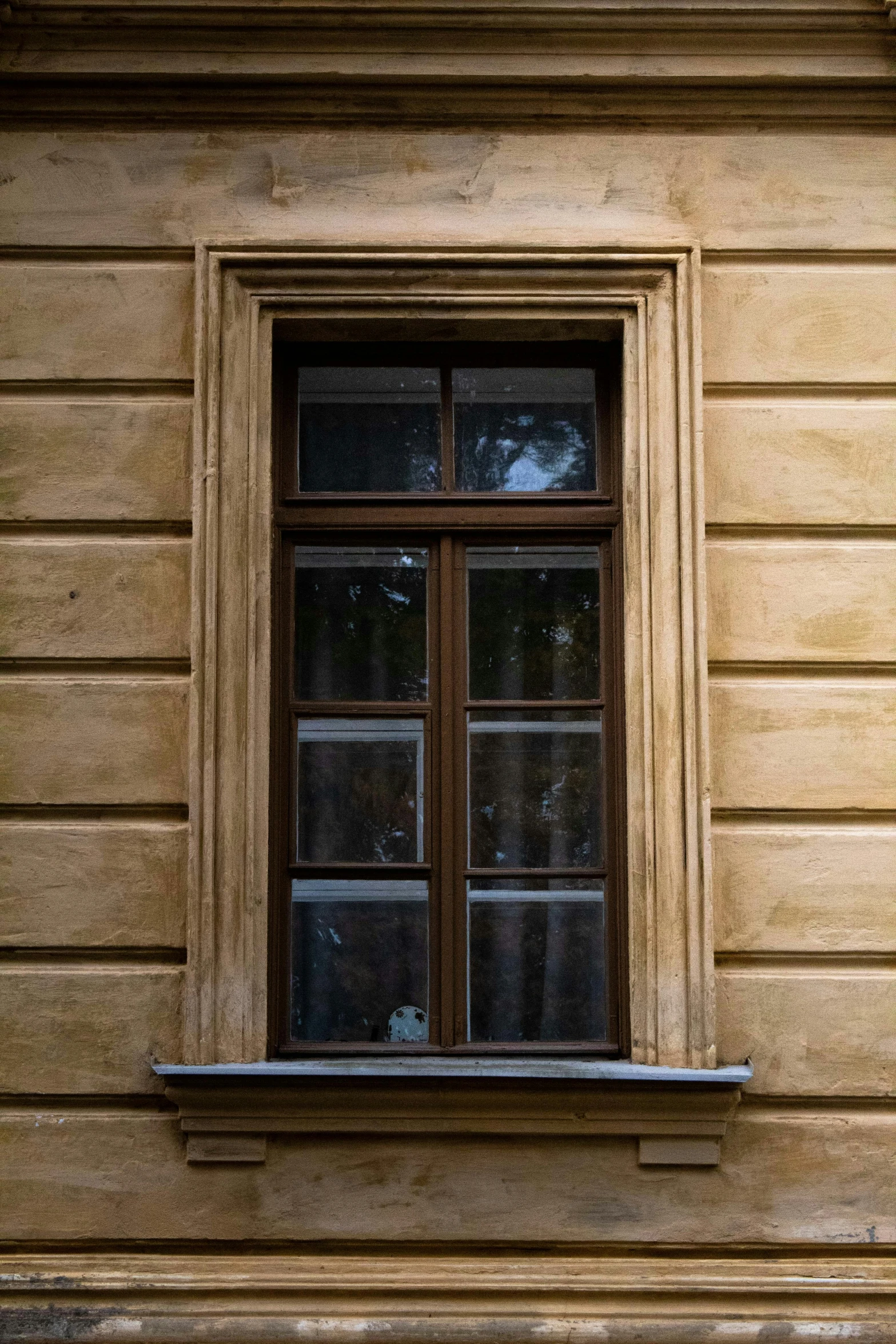 an old window on a building next to a wooden ledge