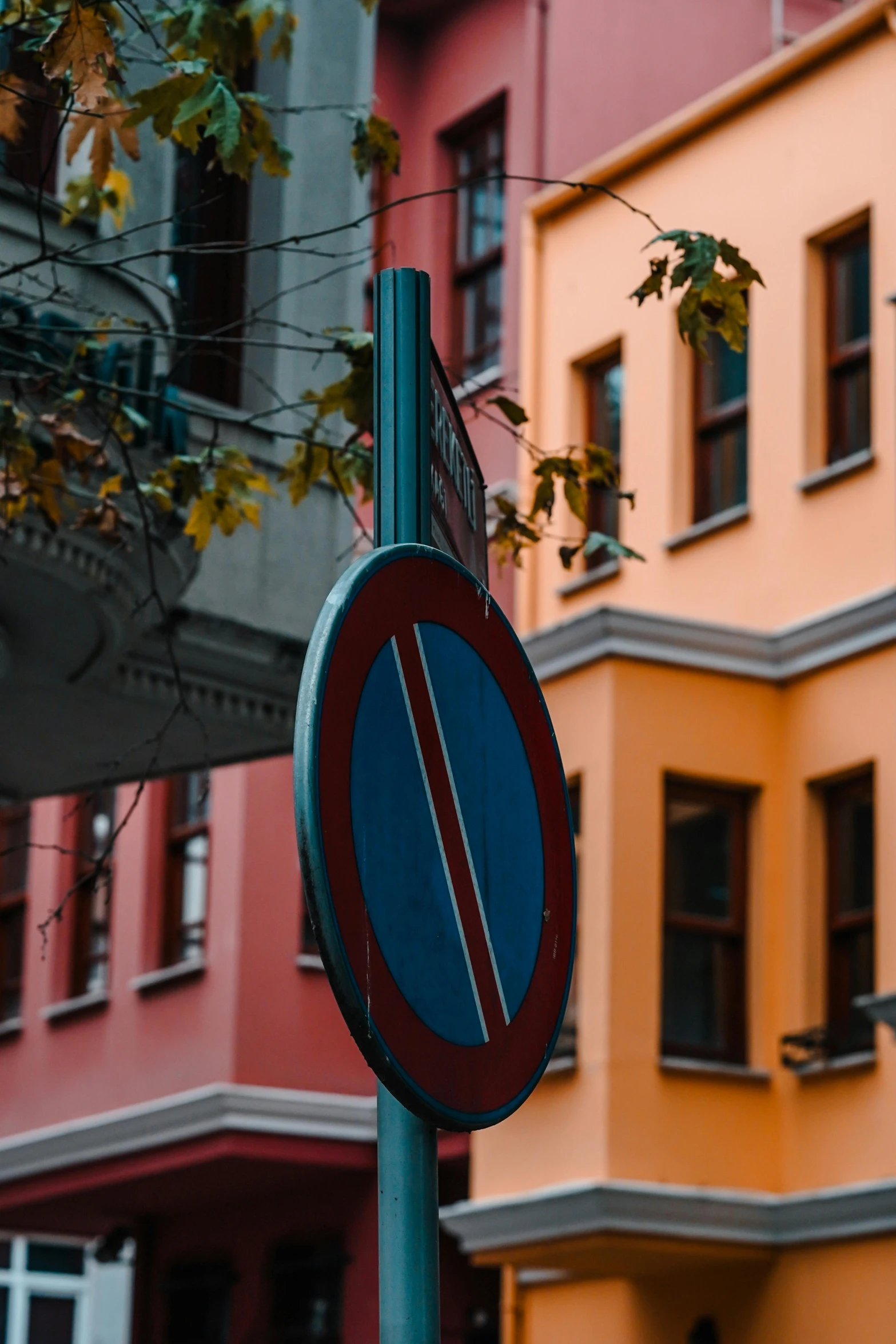 a street sign on a post next to a building