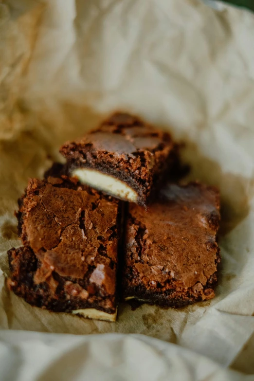 chocolate brownies with cream filling stacked on top of each other