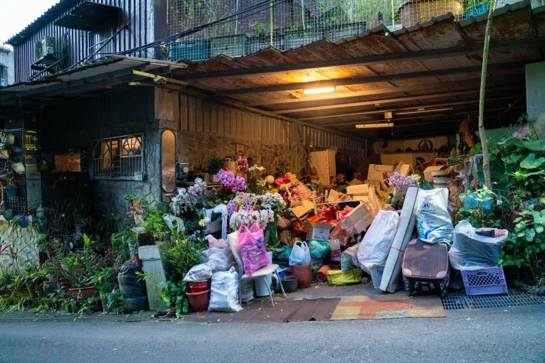 an assortment of flowers and bags in a yard