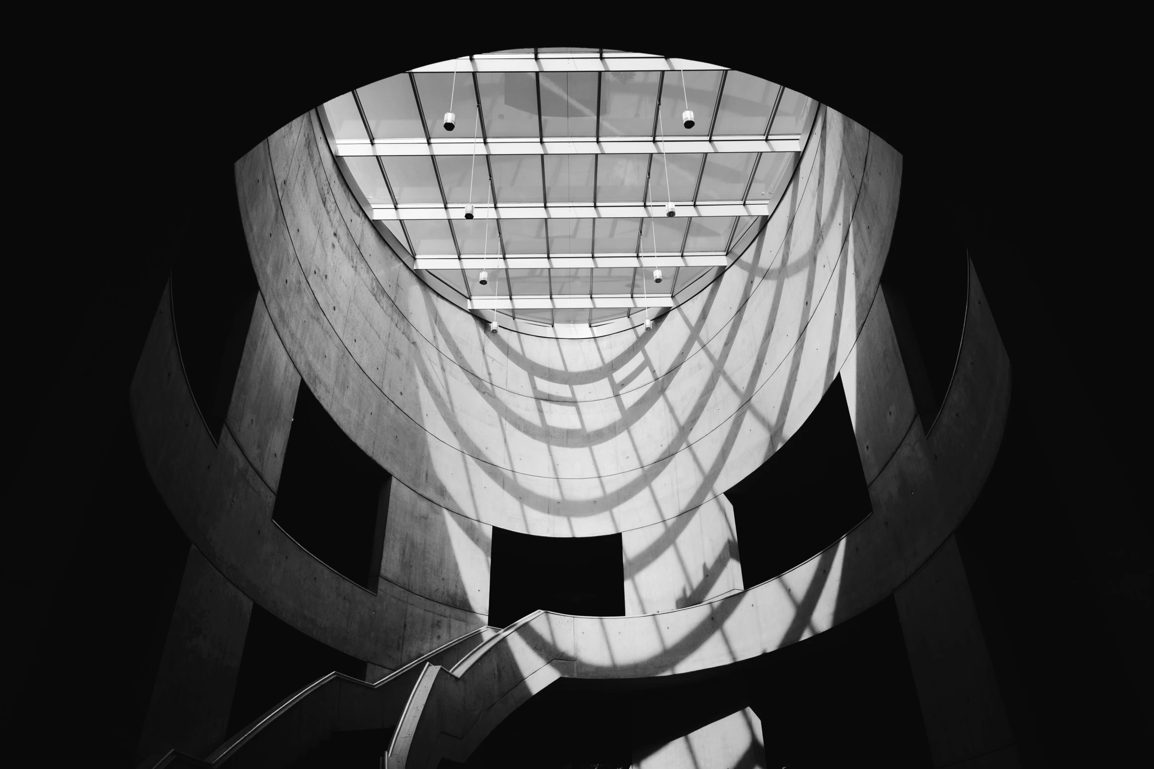 a staircase inside a modern building with a massive structure