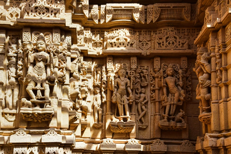 a wall with sculptures and carvings around it