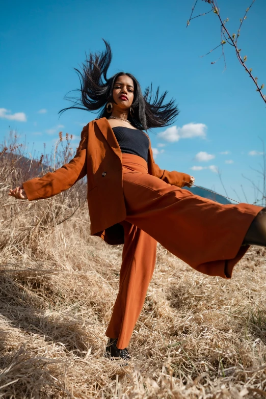 a woman that is standing in the grass