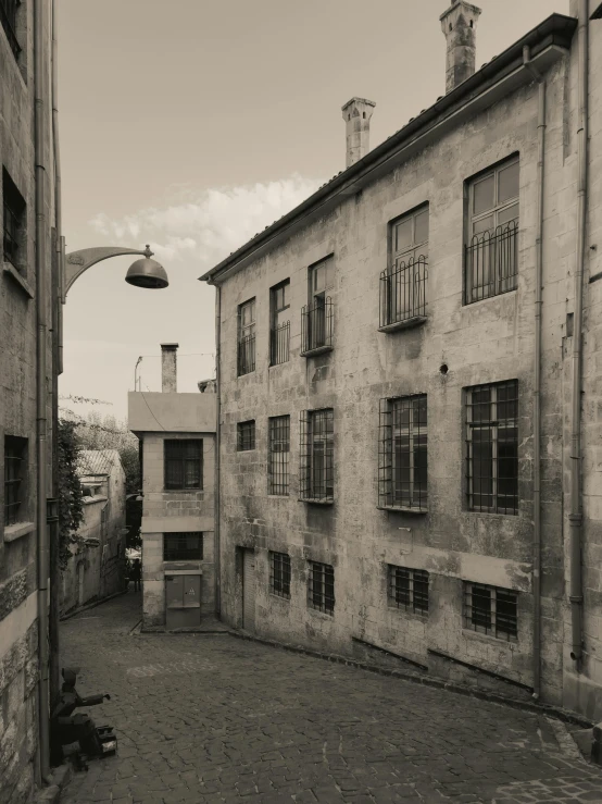 an alley that has stone buildings and cobblestones