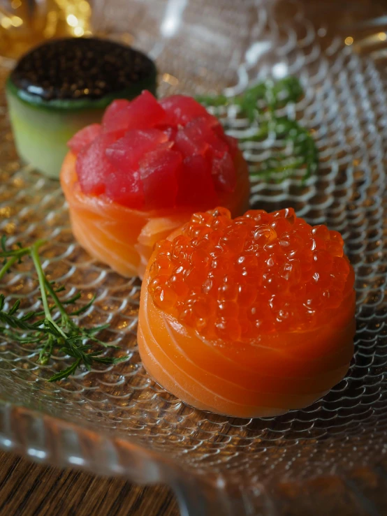 three different snacks served on a glass plate