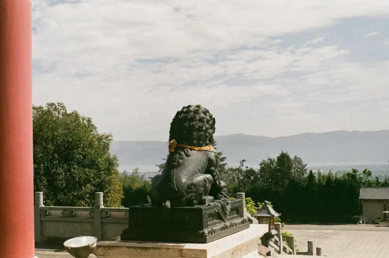 a statue of a lion sits in the middle of a courtyard