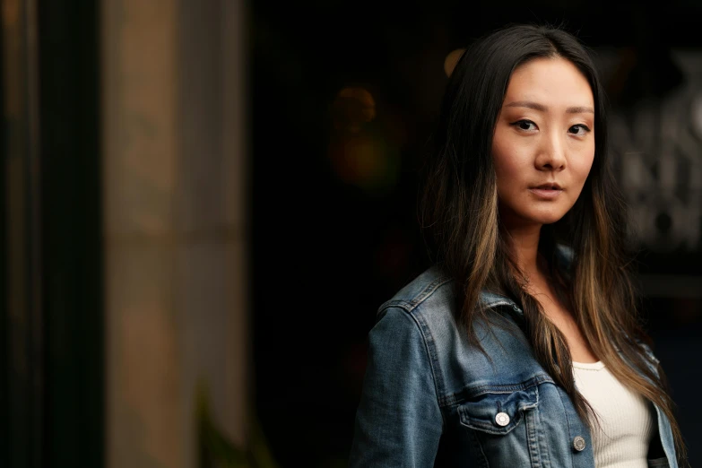 a close up of a person wearing a denim jacket