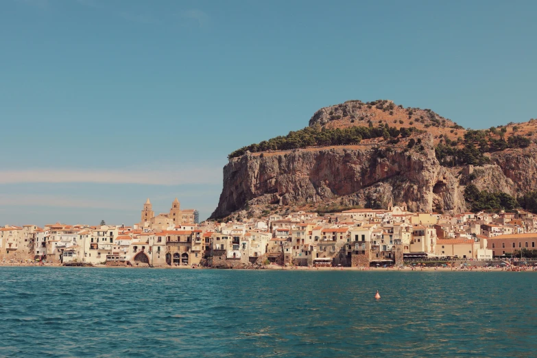 a village on the side of a mountain near a body of water