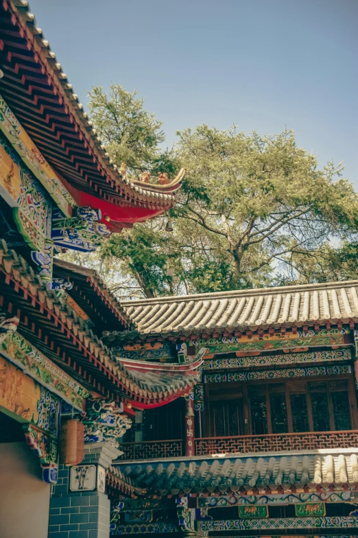 two oriental looking buildings with a lot of decorations on them