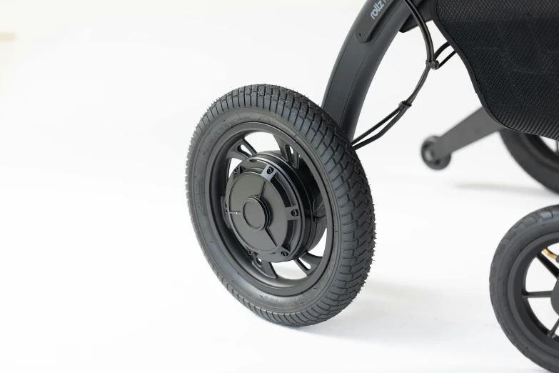 a close up of the rear wheel and tire of a stroller