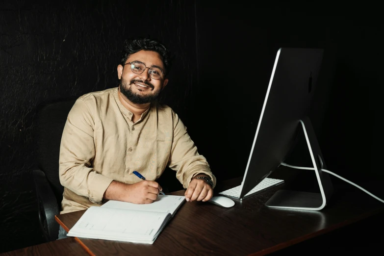 a man sitting in front of a computer