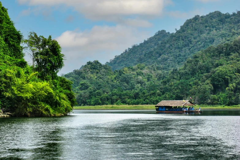 a boat is moving through a body of water with hills in the background