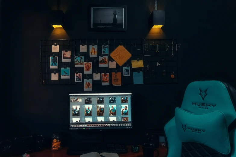 the chair is next to the computer in the dark