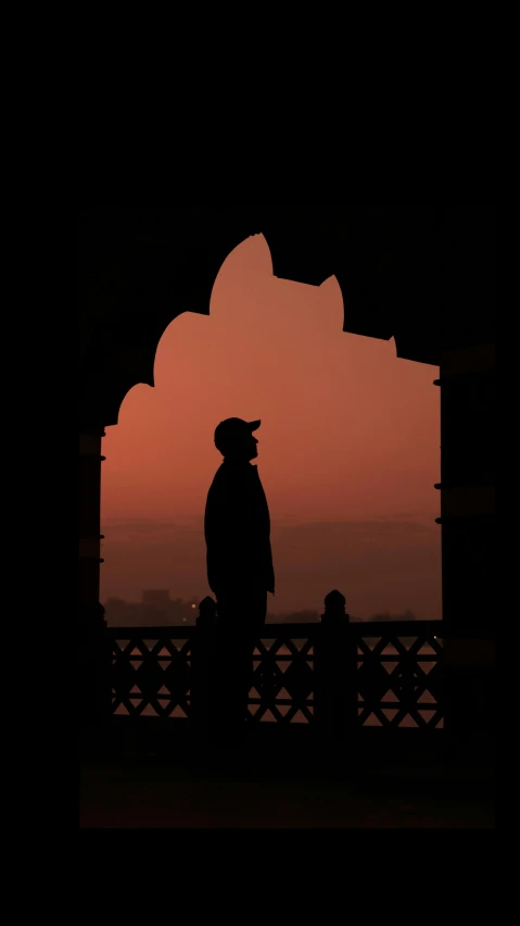 silhouette of a person in front of a archway