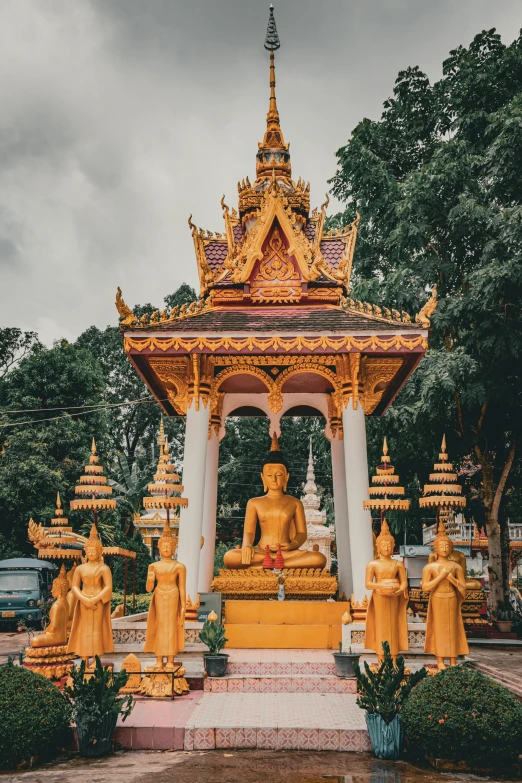 an elaborate statue sitting under a cloudy sky